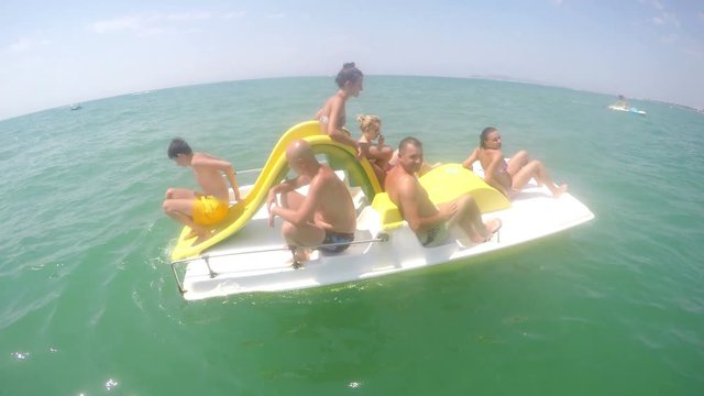 Family having fun refreshing at pedal boat ride