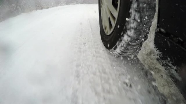 Car driving through a winter storm with snow 