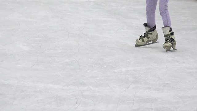 Young woman ice skating outdoors on a freezing 