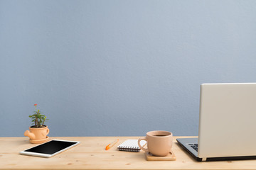 Office desk with laptop, Note paper, Euphorbia milii flower on terracotta flower pot .