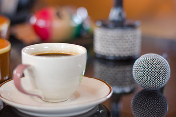 Cup of hot coffee in music  on black  background