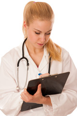 Woman doctor with stethoscope around neck showing clipboard with