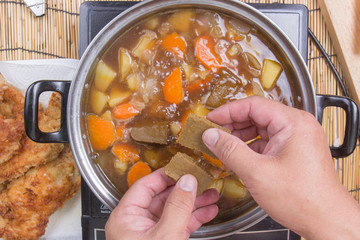 Chef putting Japanese curry pasted for cooking