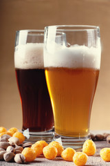 Glasses of beer, cheese balls and pistachio nuts