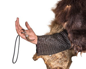 Hand Scandinavian warrior in a bearskin, with a decoration in the form of a bear tooth. Isolated on...