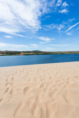 footprint on white sand dune desert and lake in Mui Ne, Vietnam