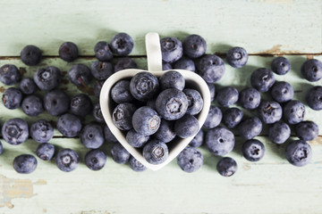Fresh blueberries on the wooden background