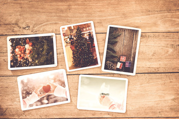 Merry christmas (xmas) photo album on old wood table. paper photo of polaroid camera - vintage and...