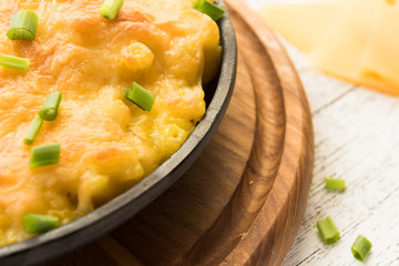 Baked cheesy pasta on the wooden background