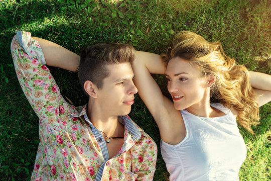 Summer in love. Close up porrait of young loving couple lying on