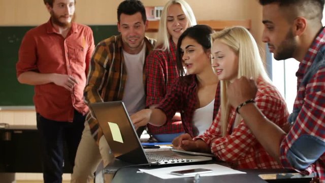 Students using laptop tablet computer people group smile