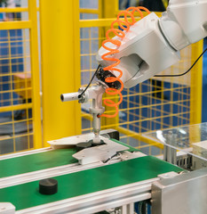 Industrial robot working in factory,Controler of robotic hand.