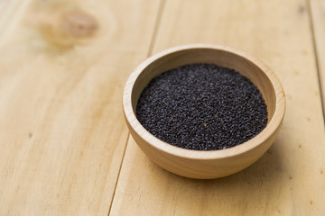Sweet basil seed in round wooden bowl