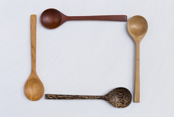 Wooden spoon design natural texture frame on white background
