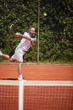 Tennis player hitting tennis ball