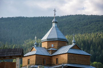 Fototapeta na wymiar Orthodox wooden Church over forest hill