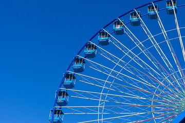 Ferris wheel with blue sky in the background
