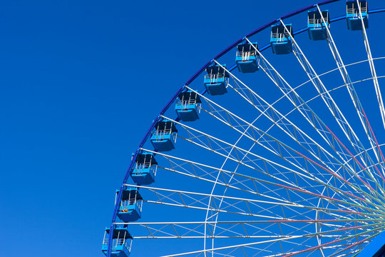 Ferris wheel with blue sky in the background
