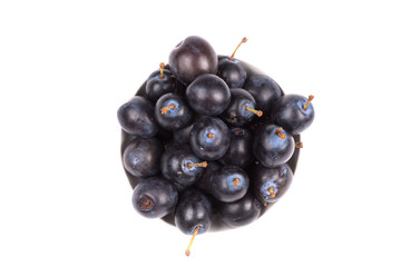 black plum in a dish isolated on a white background