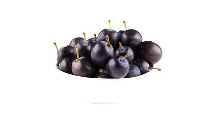 black plum in a dish isolated on a white background