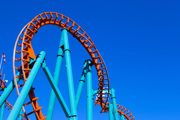 Orange rollercoaster with blue sky in the background