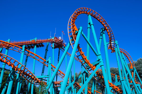 Orange rollercoaster with blue sky in the background