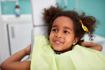 Portrait of satisfied child after dental treatment.