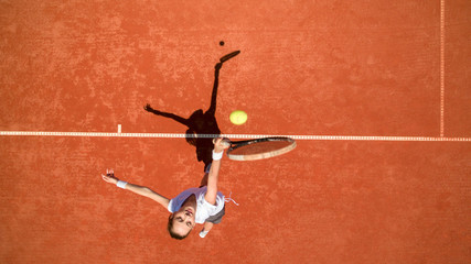 Tennis player hitting ball on tennis terrain © luckybusiness