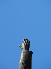 hand up against the sky, monument, gesture, direction