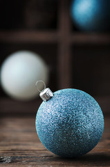 White and blue christmas balls on the wooden table