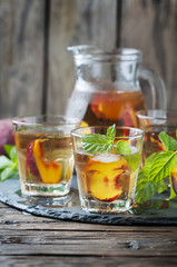 Fototapeta na wymiar Cold healthy tea with peaches and mint