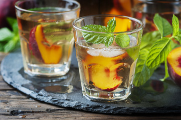Cold healthy tea with peaches and mint