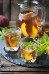 Cold healthy tea with peaches and mint
