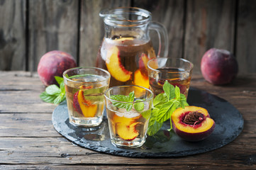 Fototapeta na wymiar Cold healthy tea with peaches and mint