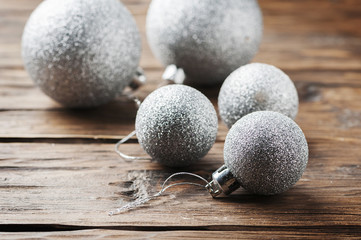 Christmas card with silver balls on the wooden table