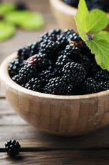 Sweet wild blackberry on the wooden table