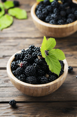 Sweet wild blackberry on the wooden table