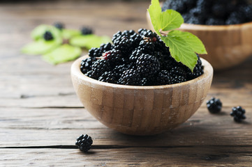 Sweet wild blackberry on the wooden table