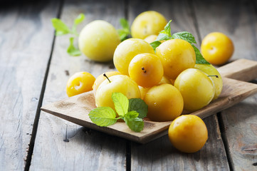 Summer sweet yellow plums on the wooden table