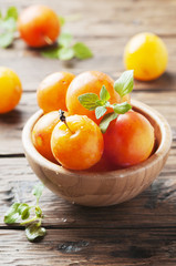 Sweet fresh yellow plums on the wooden table