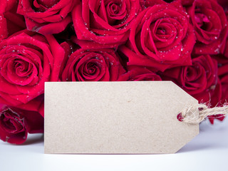 Bouquet red roses flower and blank label on isolated background