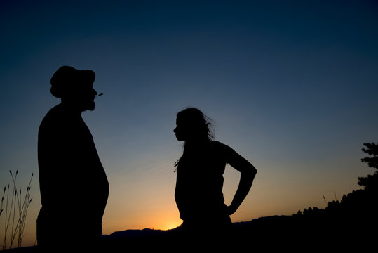 Young man and girl at sunset