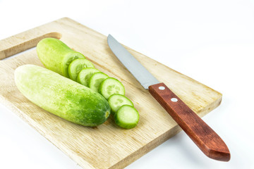 Cucumber slices on cutting board on white background