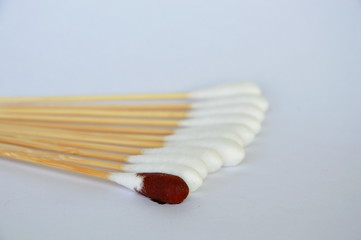 cotton bud with iodine solution on white background