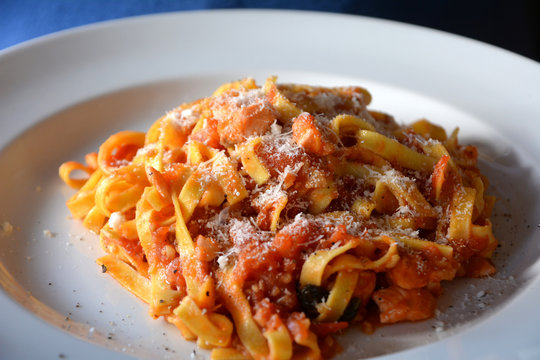 Tagliatelle al pomodoro with cheese. Italian food.