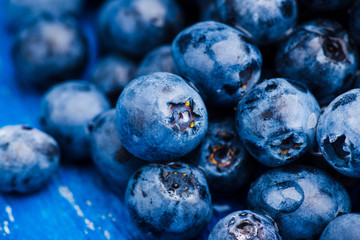 Ripe blueberries on the wooden background