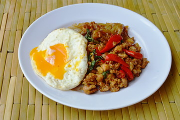 fried large noodle and spicy minced pork with basil leaf topping egg