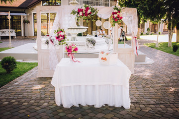 Wedding ceremony decoration. Table flowers decor. wedding arch decorated with flowers.