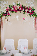 Wedding ceremony decoration. Table flowers decor. wedding arch decorated with flowers.
