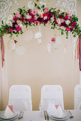 Wedding ceremony decoration. Table flowers decor. wedding arch decorated with flowers.